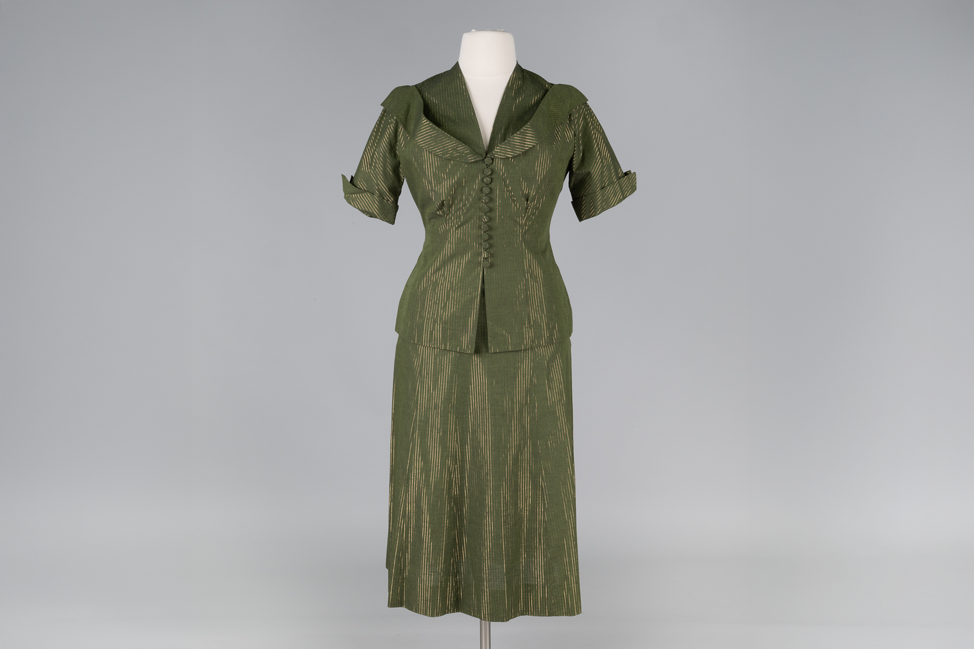 Image of Green skirt suit with gold stripes, ca. 1950